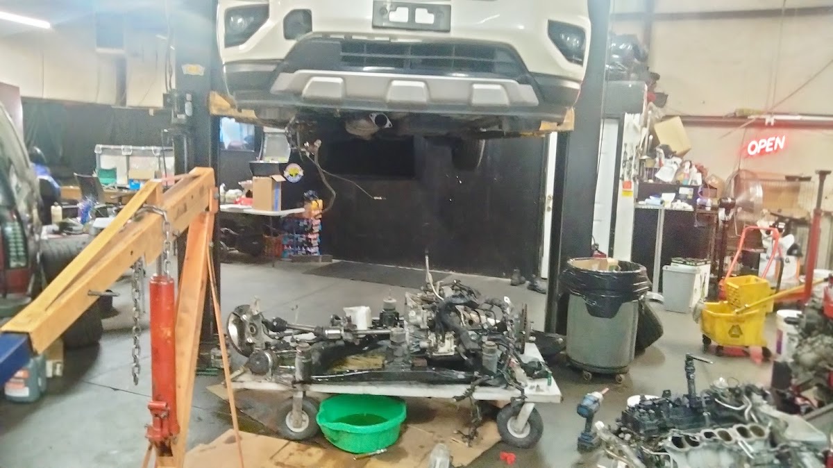 Inside Motor Man's shop in Decatur — a vehicle up on the lift and engine work underway